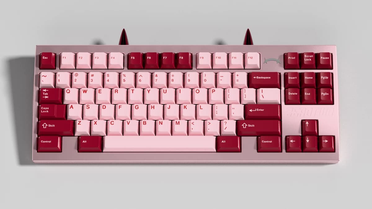 Pink and red Code:002 TKL keyboard with two rear horns.