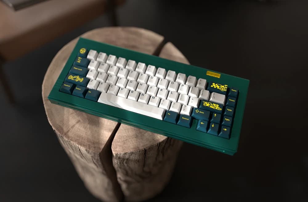 Flat Out promotional render showing light alphas, dark green modifiers and yellow motorsport novelties on a green keyboard.