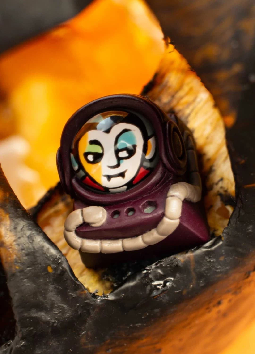 Vlad Monster Mash Cadet with a pale fanged face in a burgundy astronaut-style helmet.