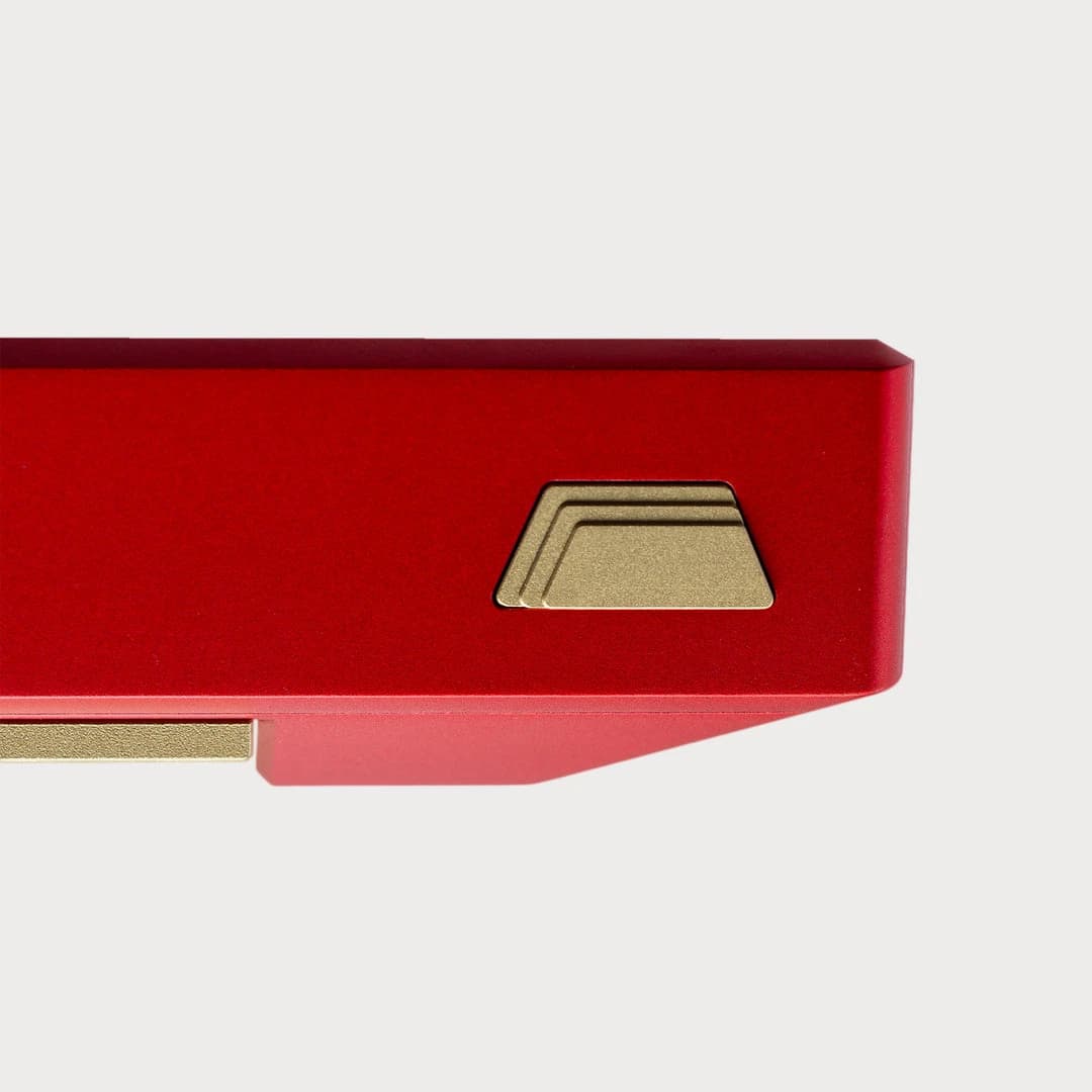 Close-up of a red Aurum case and its brass badge.