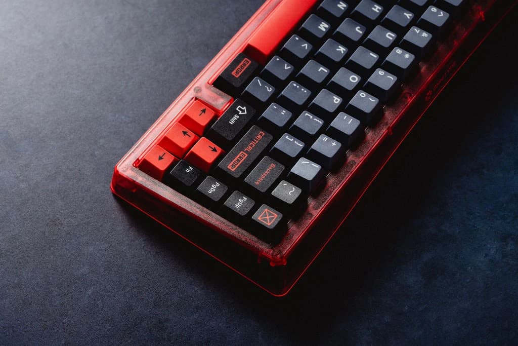 Dark Dracula keycaps with red accents on a translucent red keyboard.